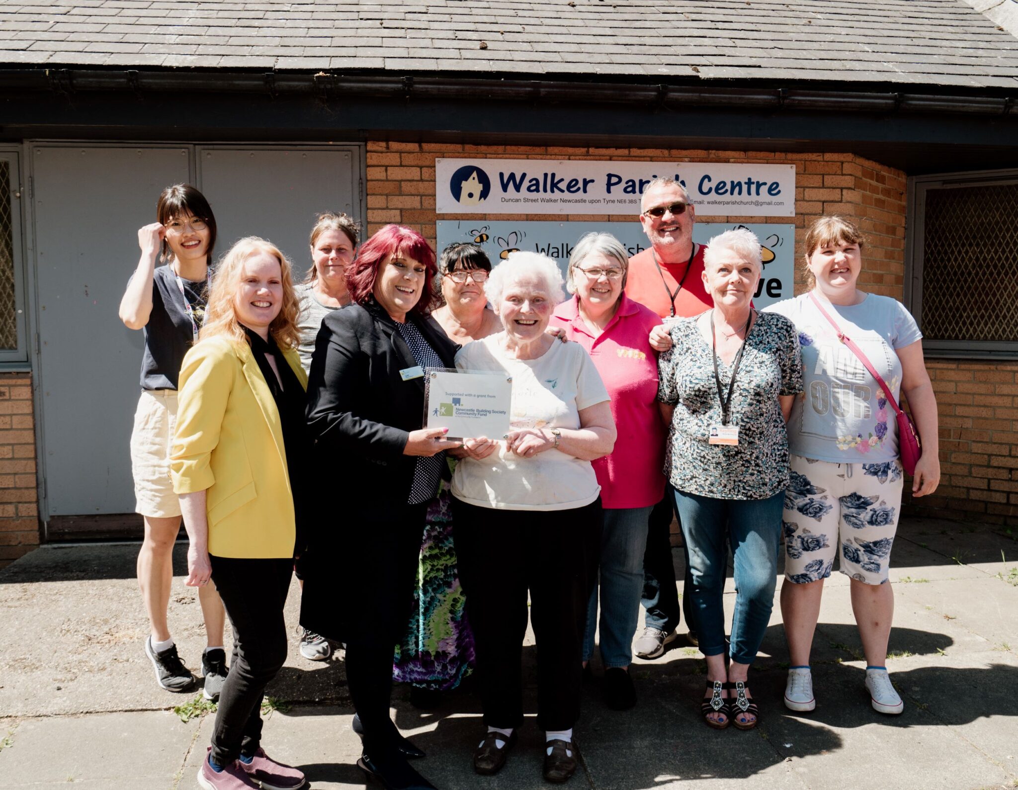 (centre) Lynn Richardson of Newcastle Building Society with Judith Dickinson of YMCA Newcastle, along with other members of the YMCA Newcastle team