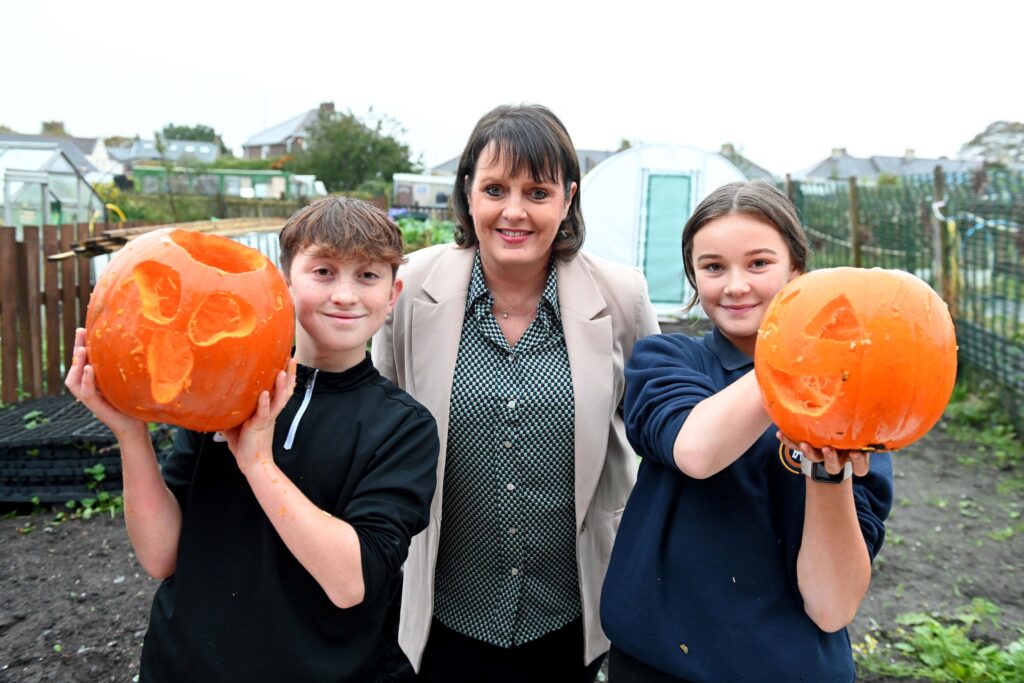 Sue Scott, head of mortgage service centre at Newcastle Building Society, with Roots to Health project participants Jack (left) and Darcey