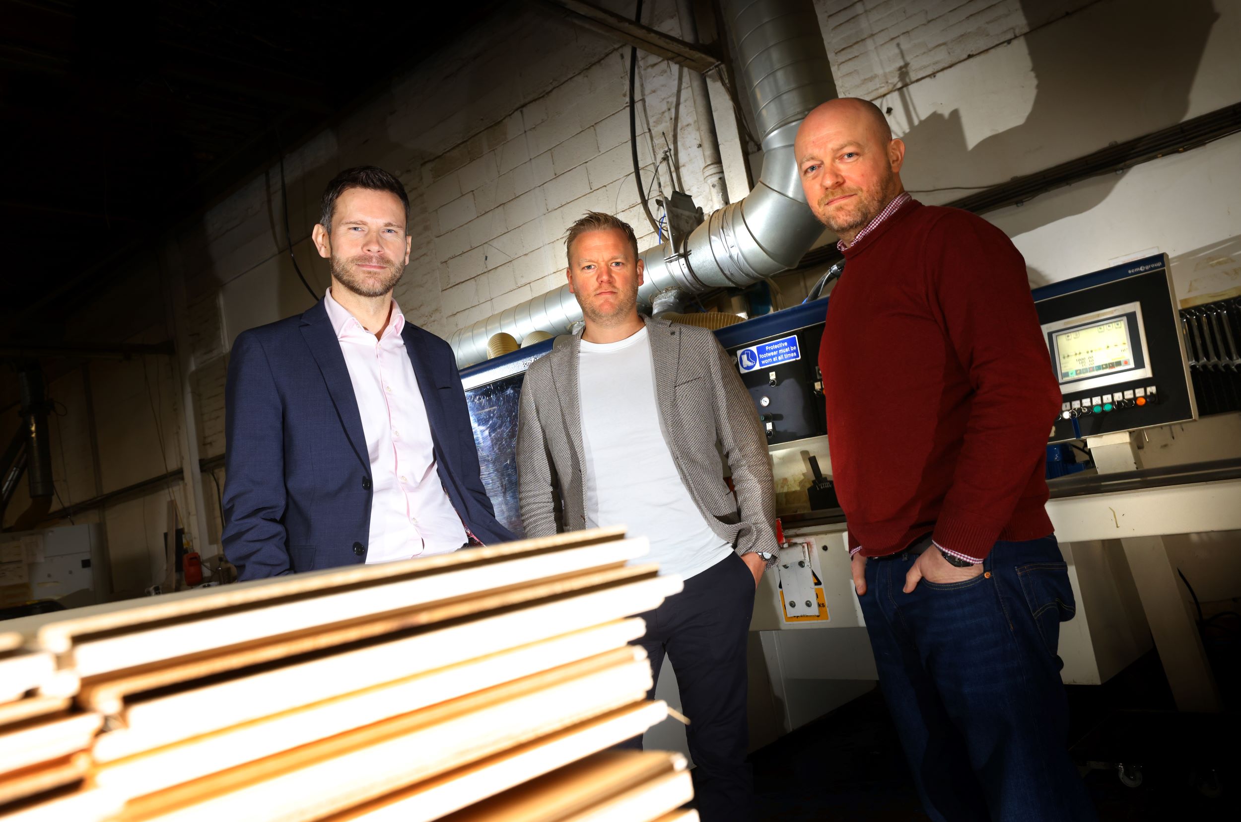 (from left) Jonathan Armitage of NEL Fund Managers with Paul Wilson and Tom Flanagan of Woodland Floors