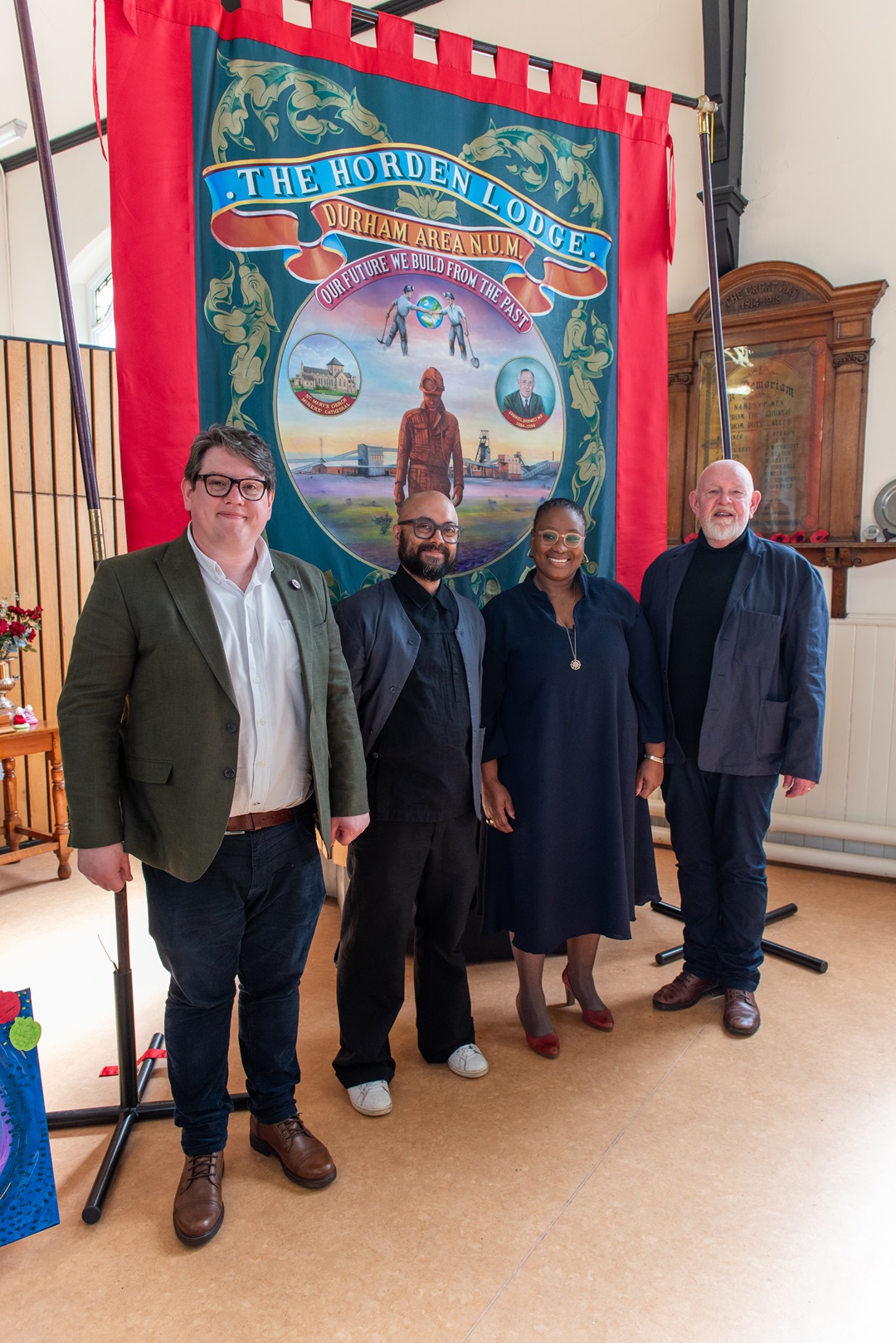 Nick Malyan (Redhills) Sud Basu (Ensemble 84), Paulina Malefane (Isango Ensemble), Mark Donford May (Ensemble 84_Isango Ensemble) with the Horden Lodge banner. Horden Methodist Church (1)