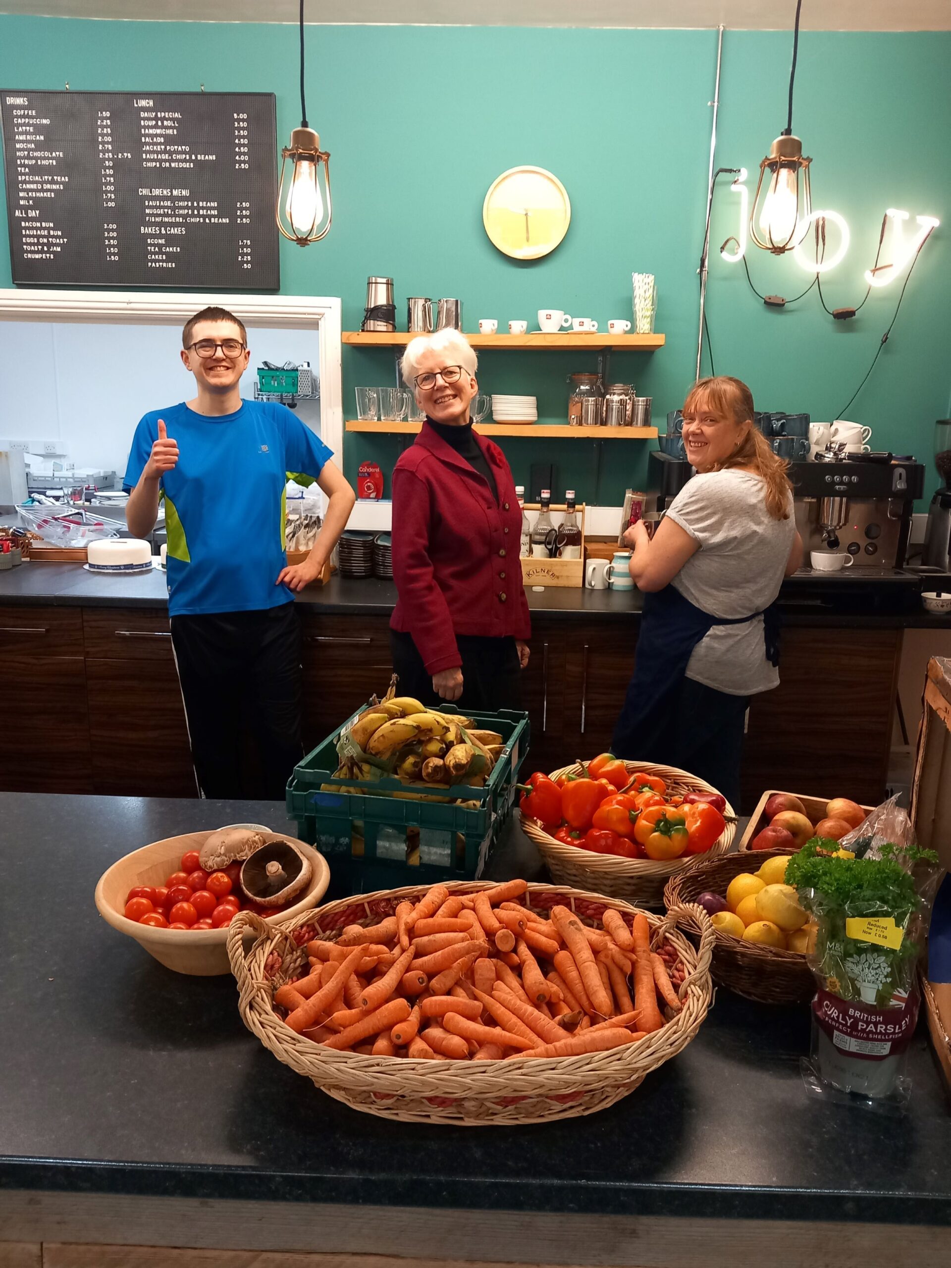 King's Cafe volunteer Lewis Boshier (left) and manager Alison Thompson (right) with Kate Culverhouse, community relations manager at the Banks Group