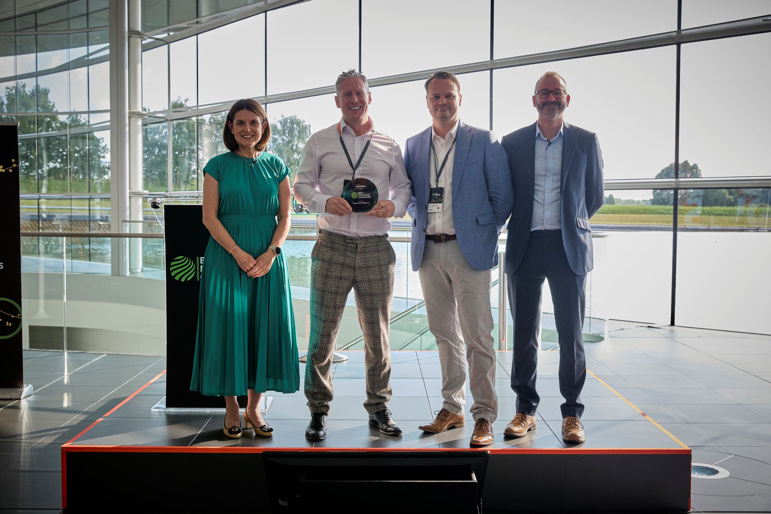 (centre) Banks' group HR director Nick Hobdey and group finance director Harry Horrocks receiving the UK Best Managed Companies programme award from Claire Evans and Matt Henderson of Deloitte