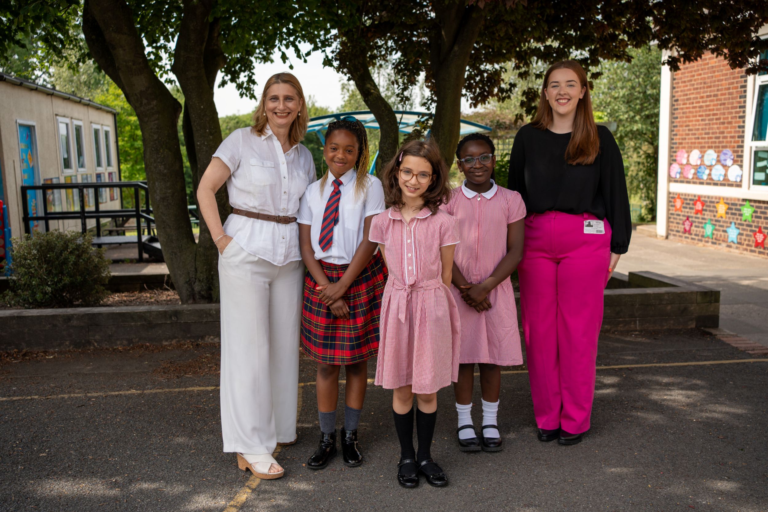 (from left) St Bede's Academy headteacher Bernadette Rizzi-Allan, Year Five pupils Angel, Sara and Iris, and OnPath Energy electrical engineer Leah Pearson