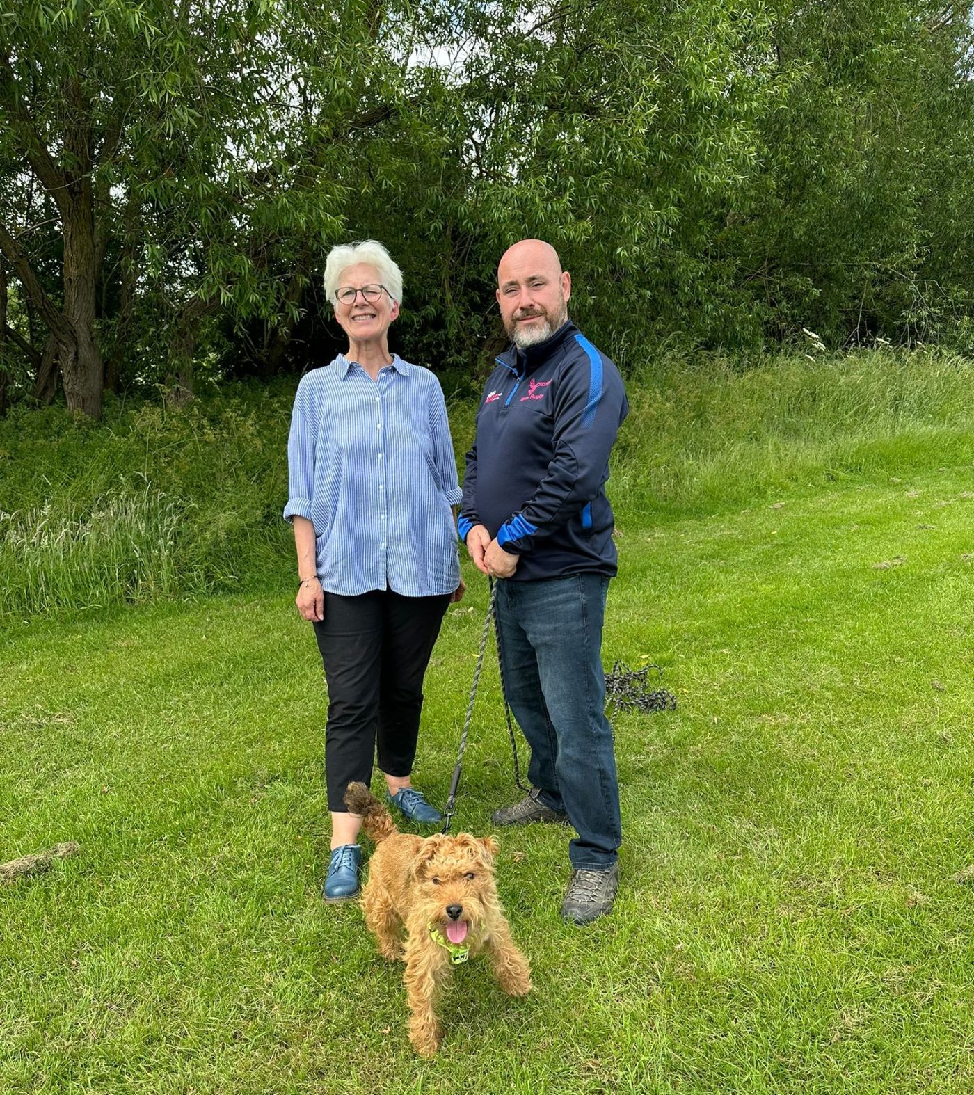 Kate Culverhouse of the Banks Group with Yarm Community Rugby Club chairman Dave Jones and his dog Ozzy