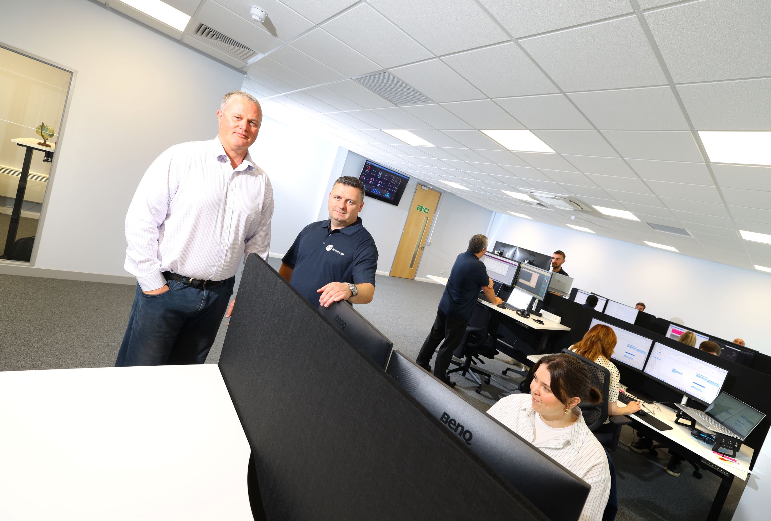 RMT Technology's commercial director Stephen McNickle and managing director Mike Hayes with members of their team in their new purpose-built office