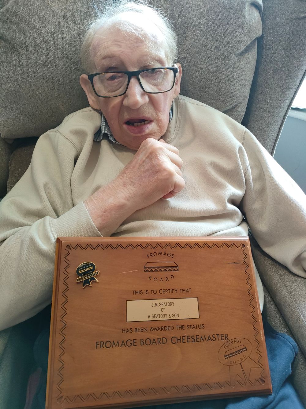 Hazelgrove Court Care Home resident Mike Seatory, 78, shows his “Fromage Board Cheesemaster” plaque during National Cheese and Wine Day.