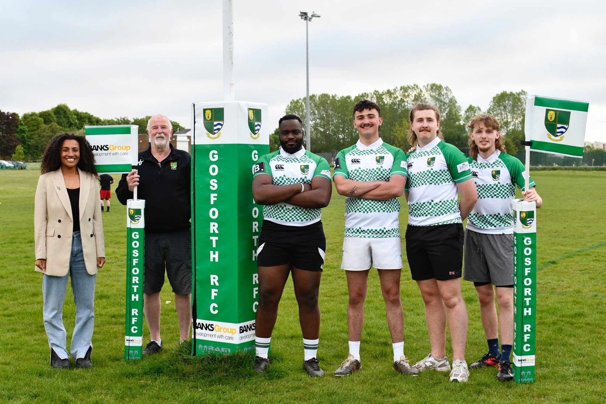 Jamilah Hassan, community relations manager at the Banks Group, with players from Gosforth Rugby Football Club